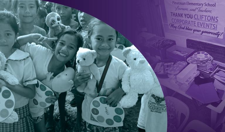 children posing with toys at a charity drive